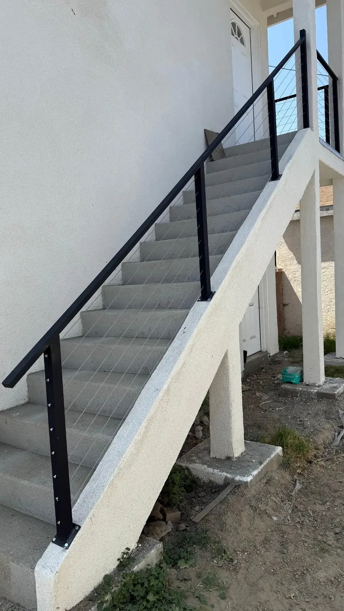 Exterior metal handrail along a stair run
