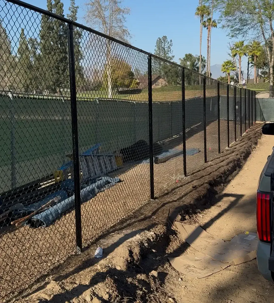 Black vinyl-coated chain link fence installed on site